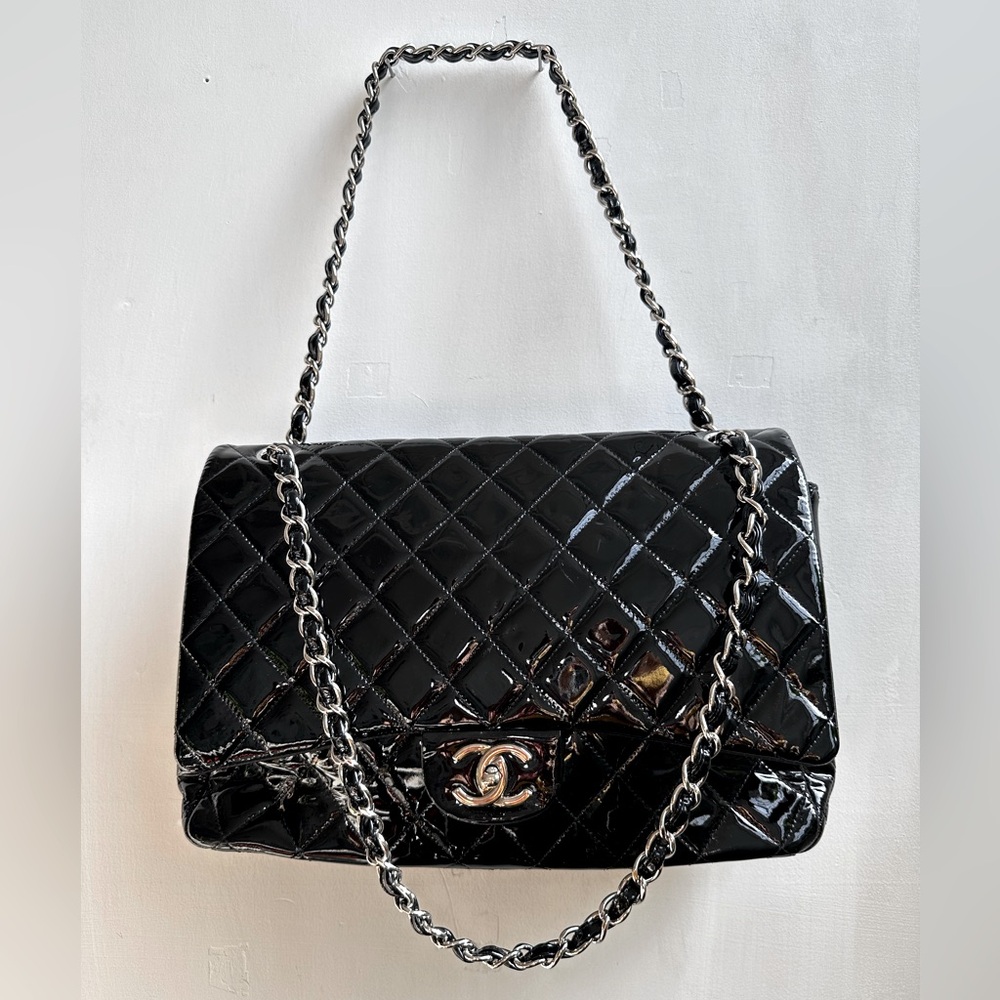 CHANEL
Black Quilted Patent Leather Classic Maxi Double Flap Bag